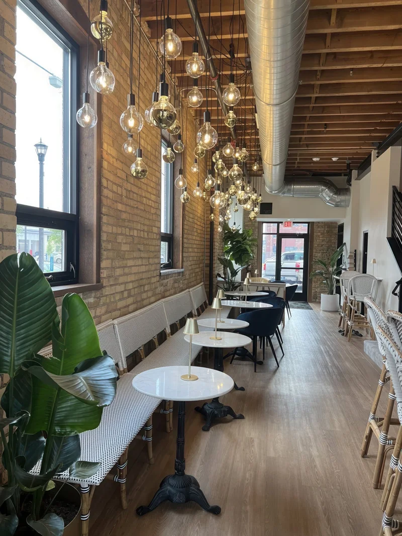 Warm restaurant dining room with pendant lights at dusk